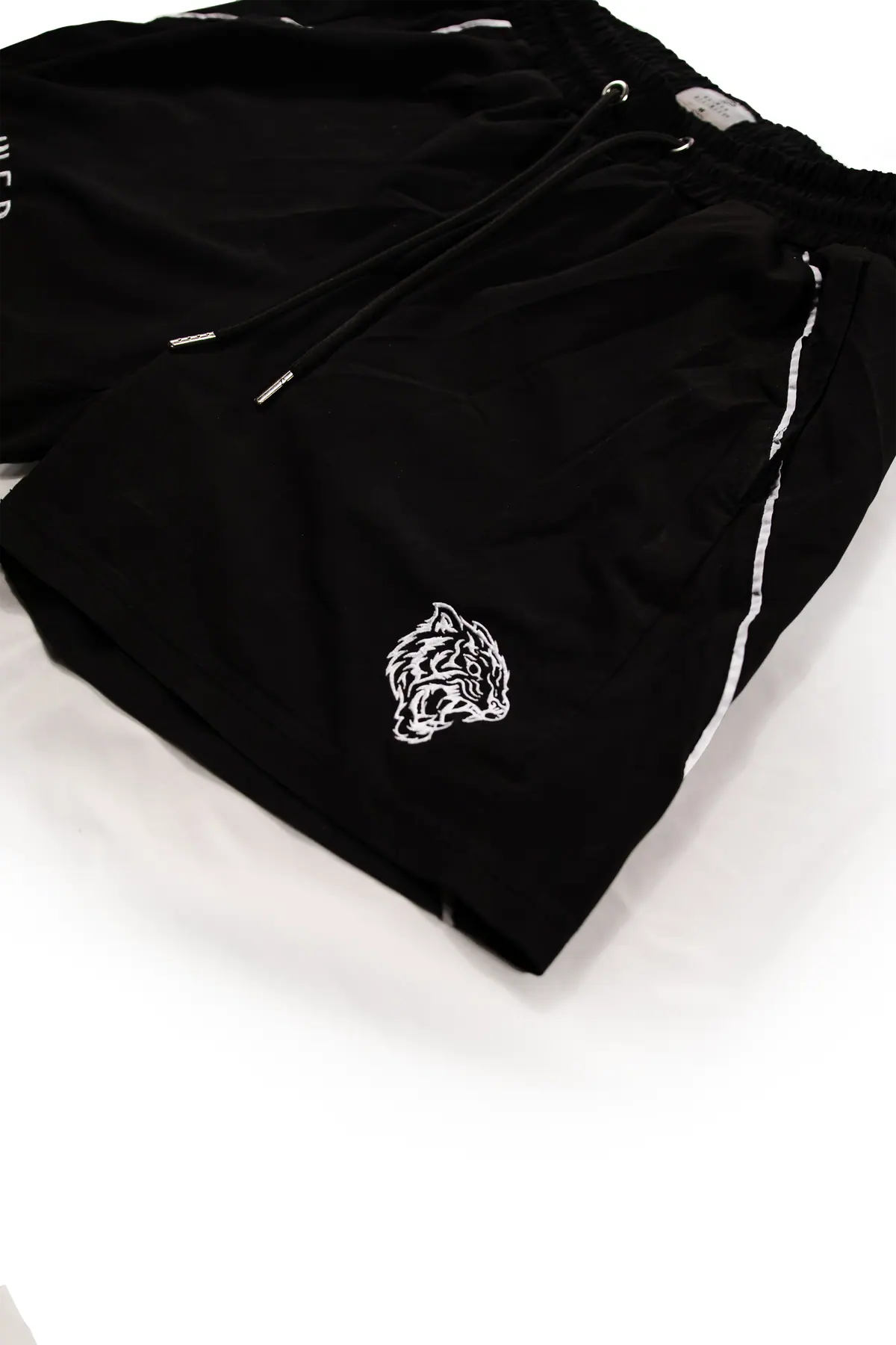 Tiger crest embroidered on black nylon shorts